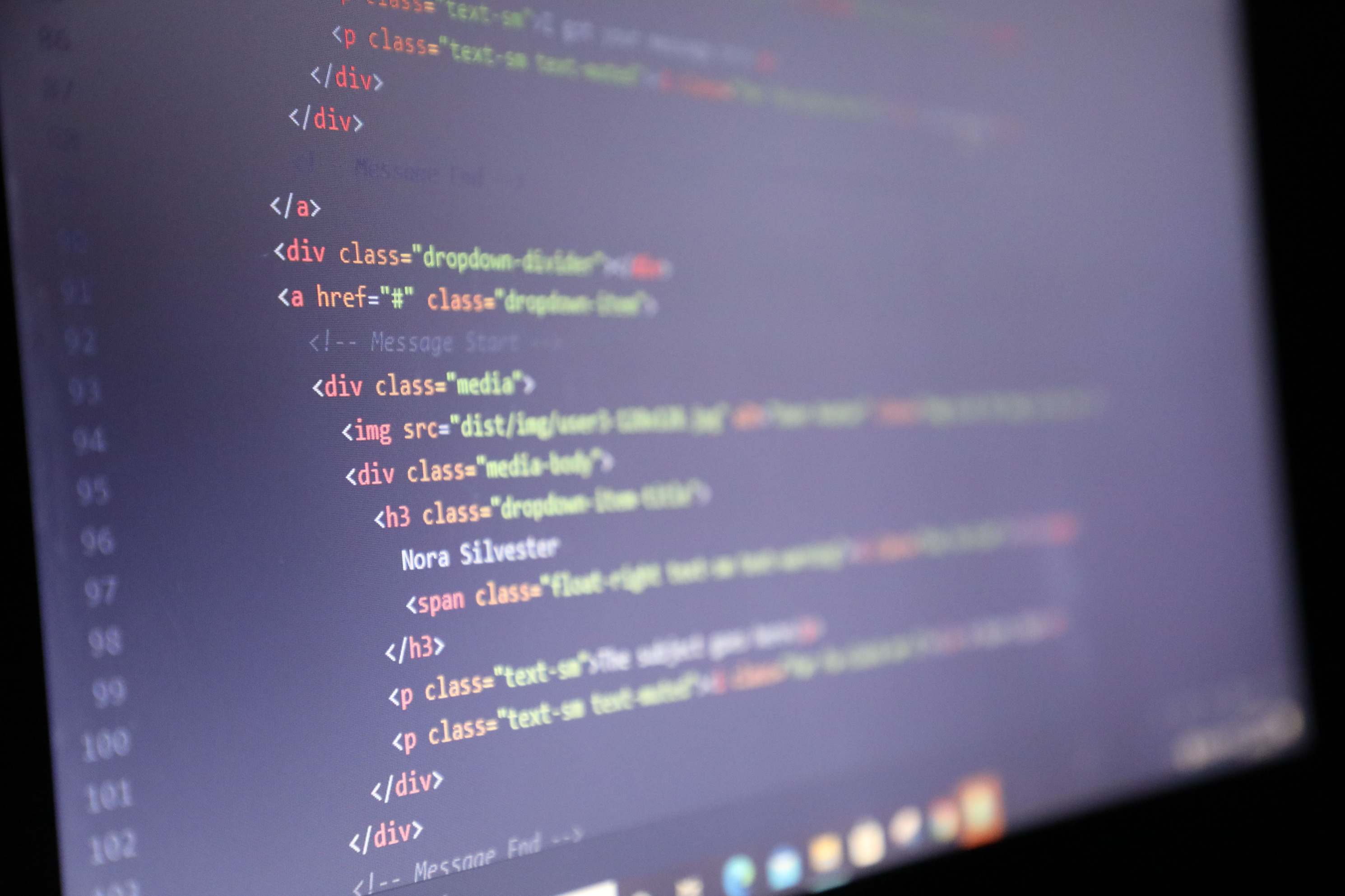 Computer screen showing illuminated HTML code in a close-up view.